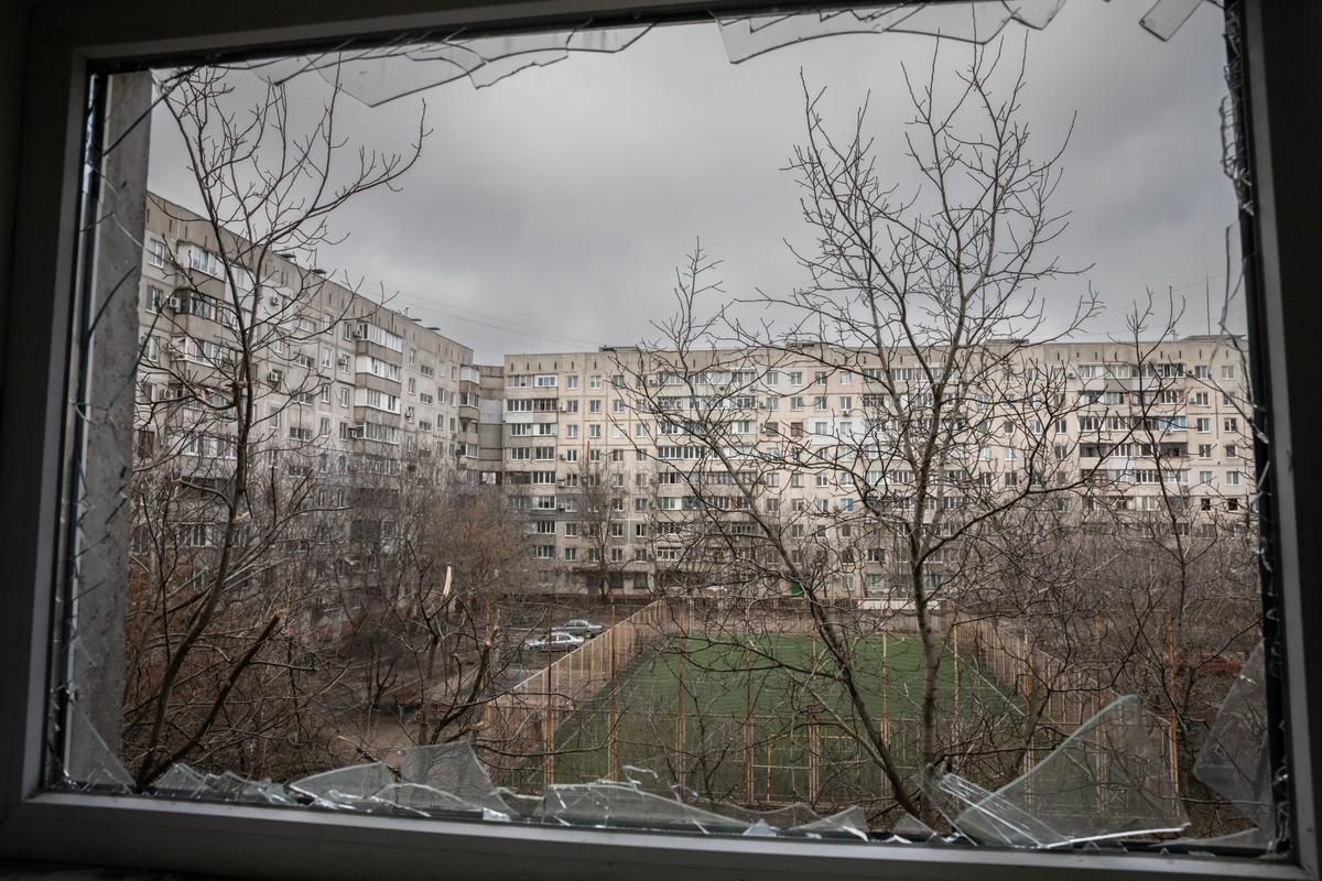 Mariupol Ukraine view of courtyard through broken glass window