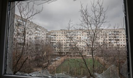 Mariupol Ukraine view of courtyard through broken glass window
