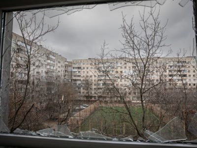 Mariupol Ukraine view of courtyard through broken glass window