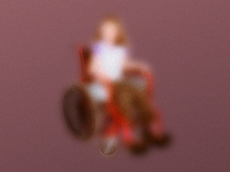 A blurred image of a young girl in a red wheelchair, on a mauve background.