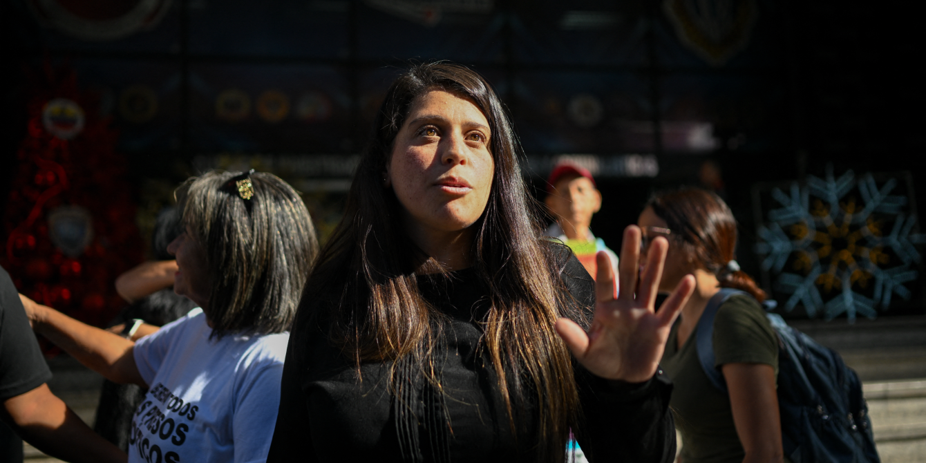 Venezuelan activist Andreina Baduel talks upon arrival at the headquarters of the Scientific, Penal, and Criminalistic Investigation Service Corps (CICPC) in Caracas on December 16, 2024. Andreina is the daughter of General Raul Baduel, an old ally and former minister of Hugo Chavez, who died in prison in 2021 after breaking with the government. She has dark brown hair, parted to the side, and is looking above the camera, with one hand raised as she gestures while speaking.
