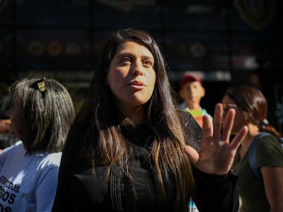 Venezuelan activist Andreina Baduel talks upon arrival at the headquarters of the Scientific, Penal, and Criminalistic Investigation Service Corps (CICPC) in Caracas on December 16, 2024. Andreina is the daughter of General Raul Baduel, an old ally and former minister of Hugo Chavez, who died in prison in 2021 after breaking with the government. She has dark brown hair, parted to the side, and is looking above the camera, with one hand raised as she gestures while speaking.