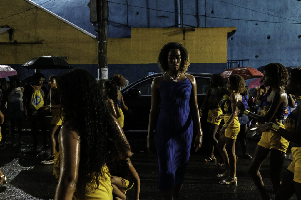 The children’s wing coordinator walks among the members as they prepare for the Unidos da Tijuca samba school’s final street rehearsal through the streets of Favela do Borel, in the Tijuca neighborhood of Rio de Janeiro, Brazil.