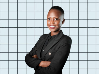 A portrait of Nerima Wako Ojiwa on a light blue grid background.