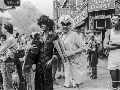 American gay liberation activist Marsha P Johnson (1945 - 1992) (center left, in dark outfit and black hair), along with unidentified others, on the corner of Christopher Street and 7th Avenue during the Pride March (later the LGBT Pride March), New York, New York, June 27, 1982. (Barbara Alper/Getty Images)