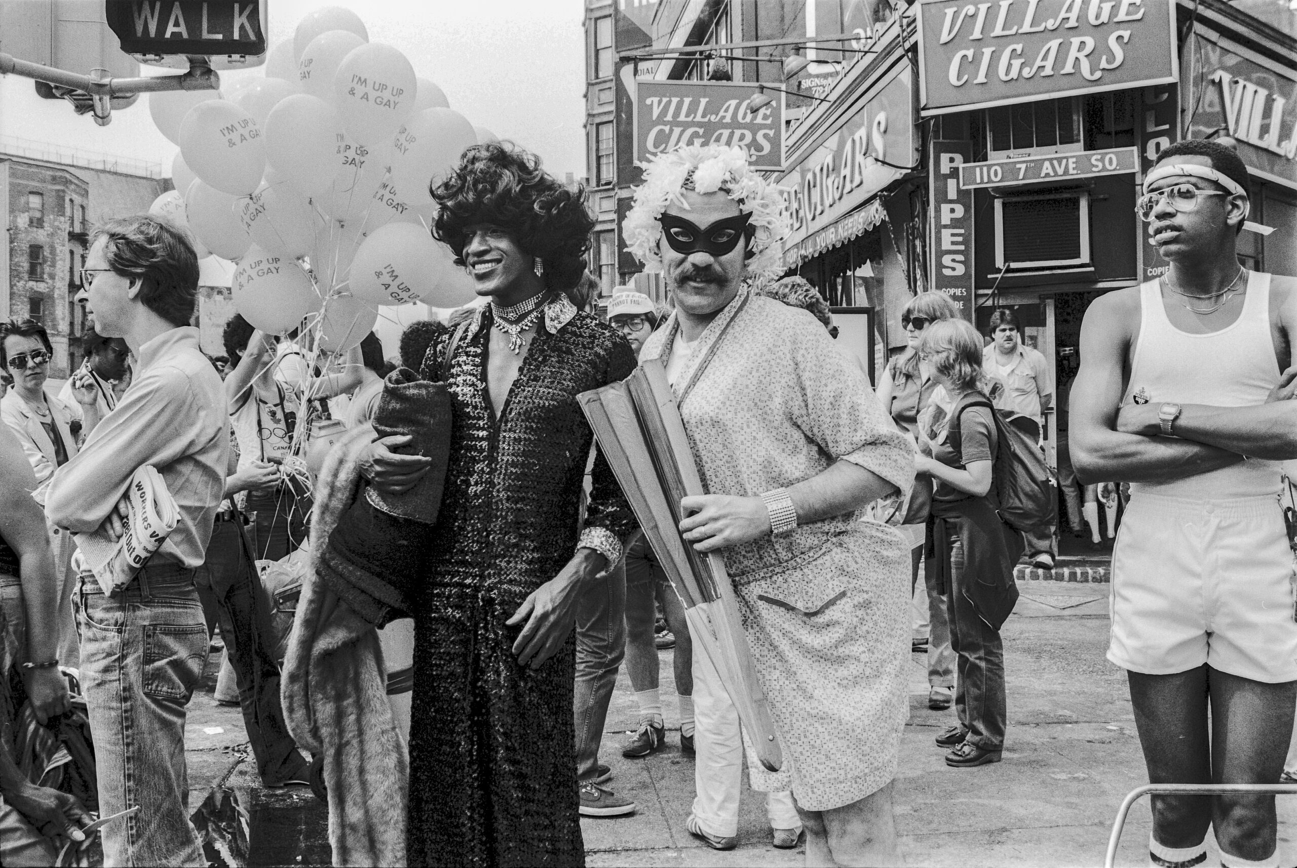 American gay liberation activist Marsha P Johnson (1945 - 1992) (center left, in dark outfit and black hair), along with unidentified others, on the corner of Christopher Street and 7th Avenue during the Pride March (later the LGBT Pride March), New York, New York, June 27, 1982. (Barbara Alper/Getty Images)