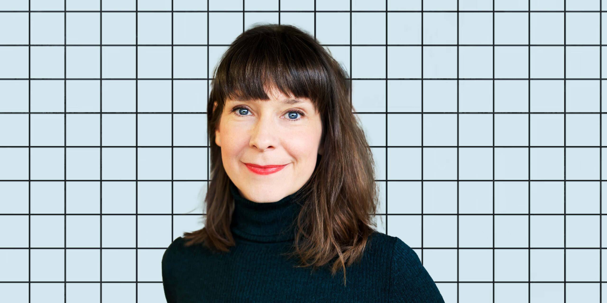 A photo of Györgyi Gálik on a blue grid background.