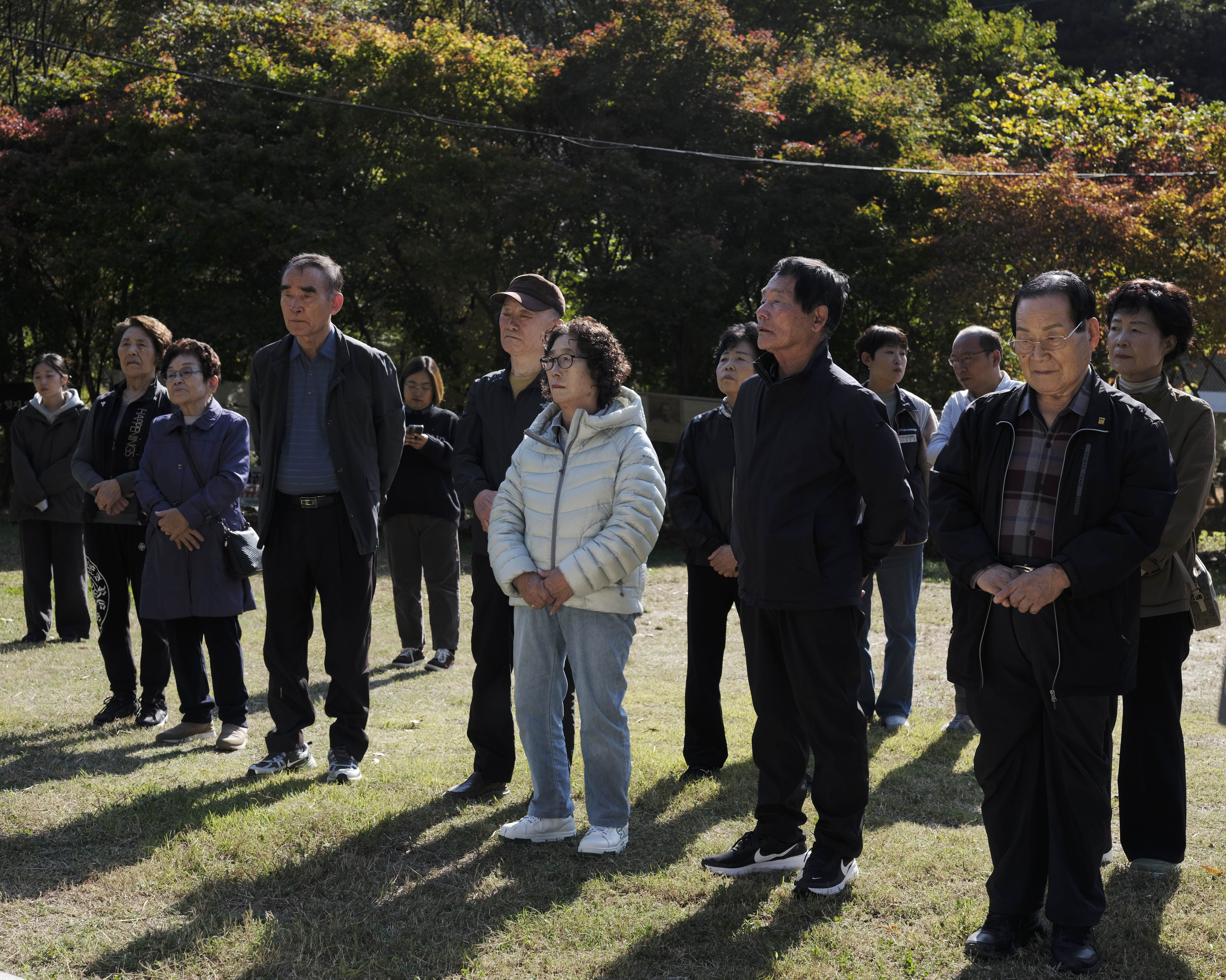 A photo of mourners gathered at the Golryeonggol massacre site.
