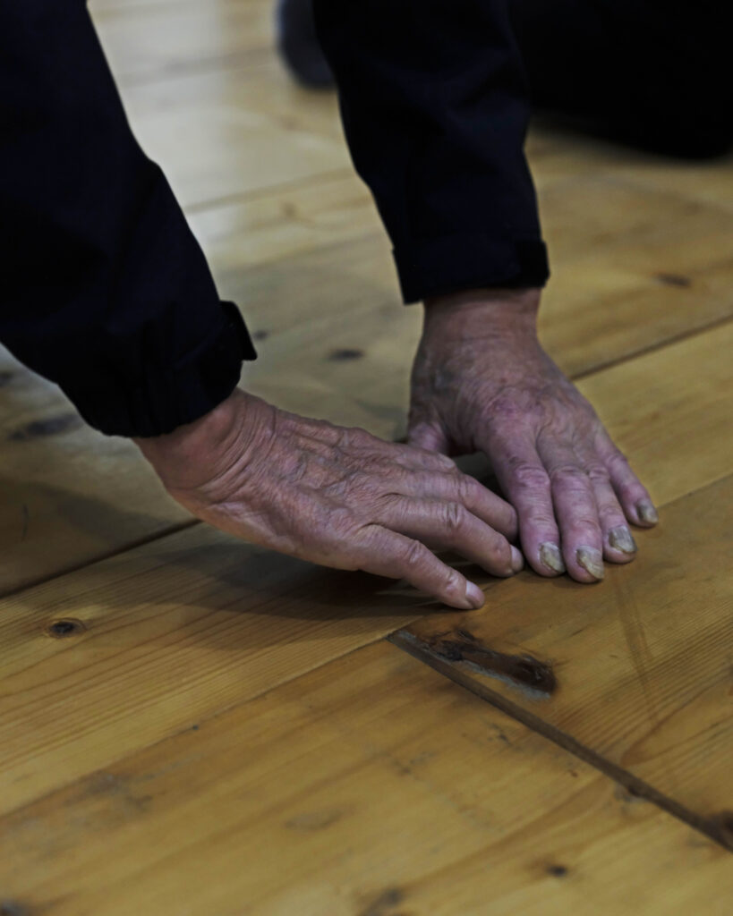 A close-up photos of two hands touching the ground.